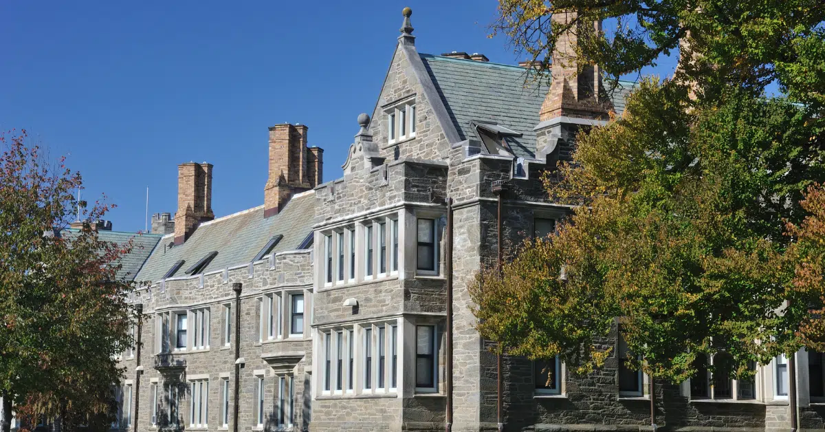 Picture of a building on Bryn Mawr's campus with a tree beside it.