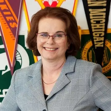 Image of Luanne Lee--a white, middle-aged woman with brown hair, wearing glasses, and a suit